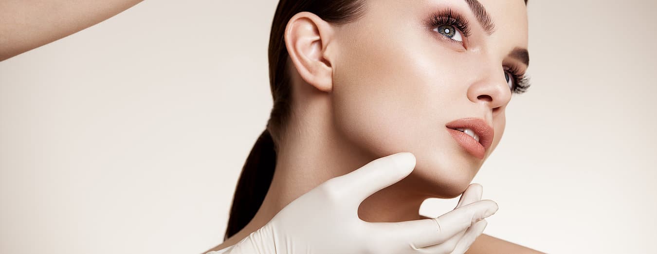 Young woman with healthy skin getting checked by surgeon